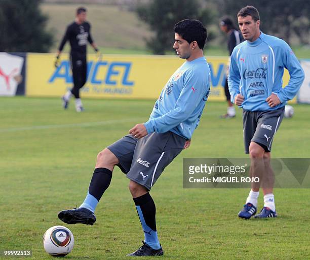 Player Luis Suarez takes part in a training session of the Uruguayan national football team next to teammate Andres Scotti at the Football...