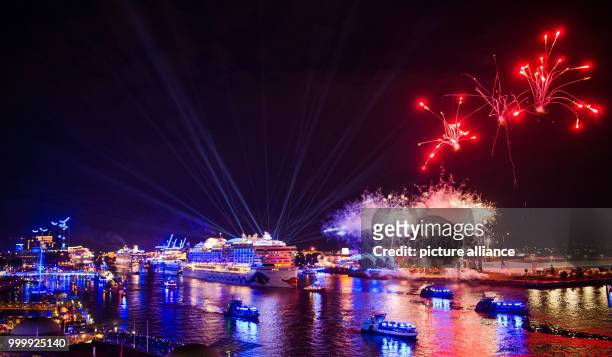 Firework display can be seen above the cruise ship 'Aida Prima' during the final parade of the cruise festival Hamburg Cruise Days at the Elbe river...