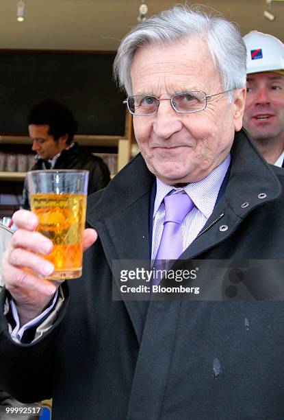 Jean-Claude Trichet, president of the European Central Bank , holds a glass of apple cider during a ceremony to lay the cornerstone for the new ECB...