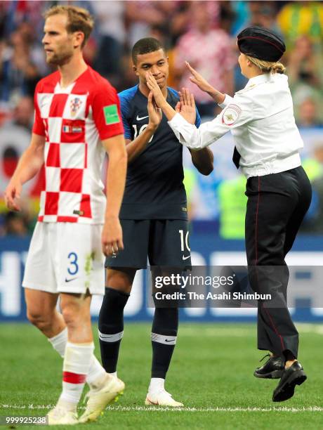 Kylian Mbappe of France high fives with a pitch invader during the 2018 FIFA World Cup Final between France and Croatia at Luzhniki Stadium on July...