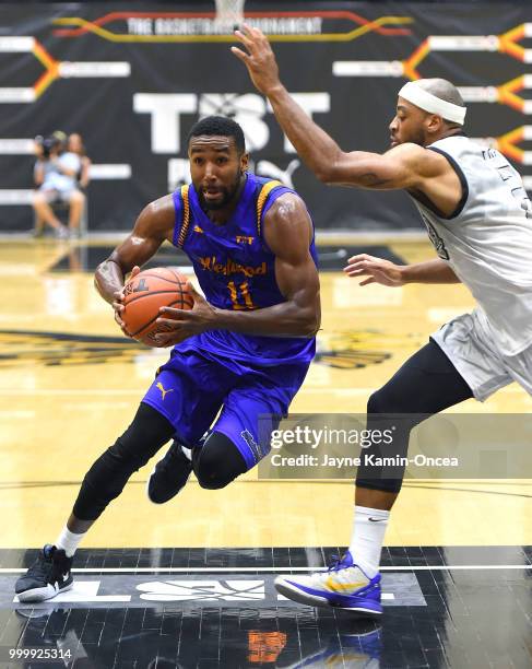 Monyea Pratt of the Albuquerque Hoops guards Malcolm Lee of the Sons of Westwood as he drives to the basket during the Western Regional of The...