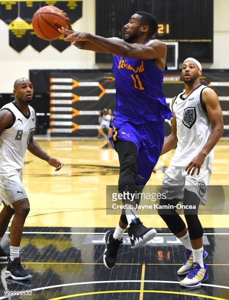 Malcolm Lee of the Sons of Westwood gets past Monyea Pratt and DeAndre Lansdowne of the Albuquerque Hoops as he passes the ball during the Western...