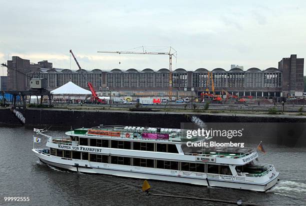 Boat sails on the Main river across from the former central market or Grossmarkthalle, as construction cranes stand near the site of the new European...