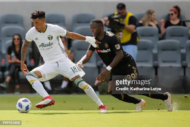 Julio Cascante of the Portland Timbers and Adama Diomande of the Los Angeles Football Club fight for control of the ball at Banc of California...