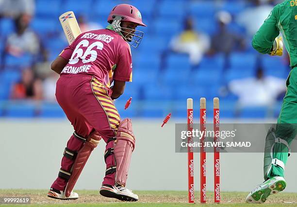 South African wicketkeeper AB de Villiers breaks the wicket to dismiss West Indies batsman Narsingh Deonarine during the first T20 match between West...