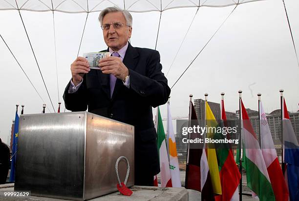 Jean-Claude Trichet, president of the European Central Bank , holds a selection of euro notes during a ceremony to lay the cornerstone for the new...