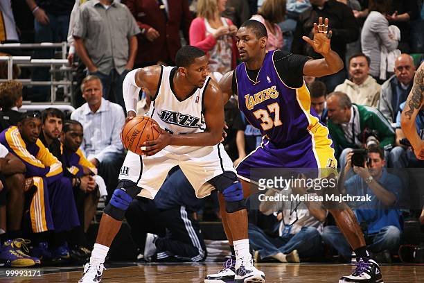 Miles of the Utah Jazz looks to move the ball against Ron Artest of the Los Angeles Lakers in Game Four of the Western Conference Semifinals during...