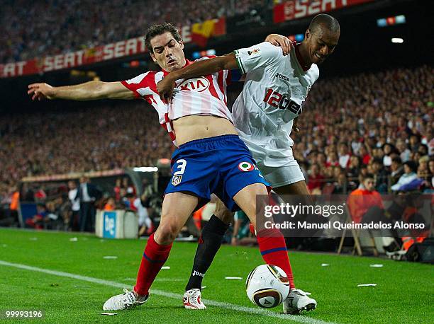 Konko of Sevilla and Antonio Lopez of Atletico de Madrid compete for the ball during the Copa del Rey final between Atletico de Madrid and Sevilla at...