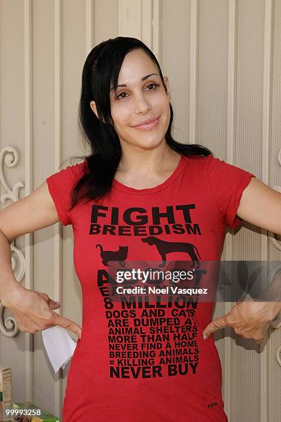 Nadya "Octomom" Suleman unveils a banner for pet birth control in front of her home on May 19, 2010 in La Habra, Orange, California.