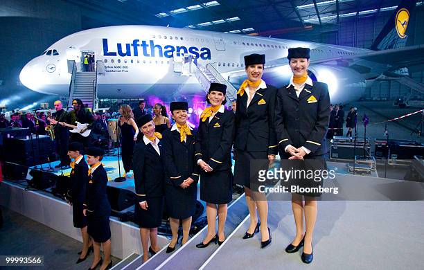 Lufthansa cabin attendants stand for a picture in front of the first Lufthansa Airbus A380 airplane in Frankfurt, Germany, on Wednesday, May 19,...