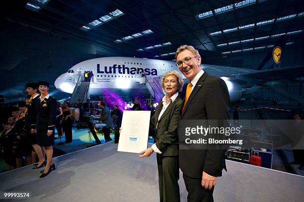 Wolfgang Mayrhuber, chief executive officer of Lufthansa AG, smiles as he stands with Petra Roth, mayor of Frankfurt, during a ceremony following the...