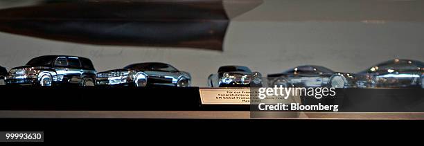 Models of General Motors Co. Cars that were designed under the tenure of Robert "Bob" Lutz, former vice chairman of GM, are seen in a case that was...