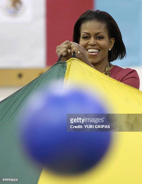 First Lady Michelle Obama takes part in gym class activities as she visits New Hampshire Elementary School with Mexico's first lady Margarita Zavala...