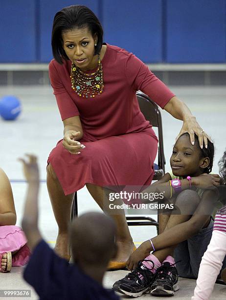 First Lady Michelle Obama speaks with students during a gym class as she and Mexican First Lady Margarita Zavala Calderon visit New Hampshire...