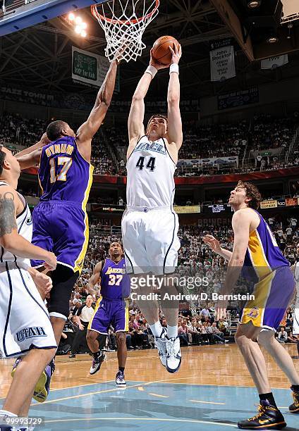 Kyrylo Fesenko of the Utah Jazz takes the ball to the basket against Andrew Bynum and Pau Gasol of the Los Angeles Lakers in Game Three of the...