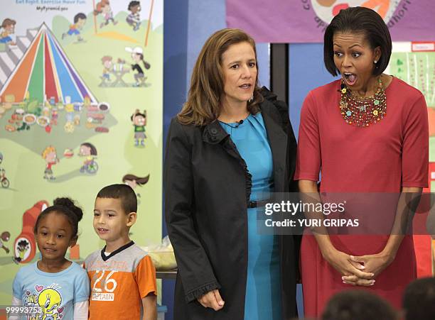 First Lady Michelle Obama reacts next to Mexican first lady Margarita Zavala during a lunch at New Hampshire Elementary School in Silver Spring,...