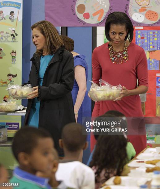First Lady Michelle Obama and Mexican First Lady Margarita Zavala serve a food for children during a lunch at New Hampshire Elementary School in...