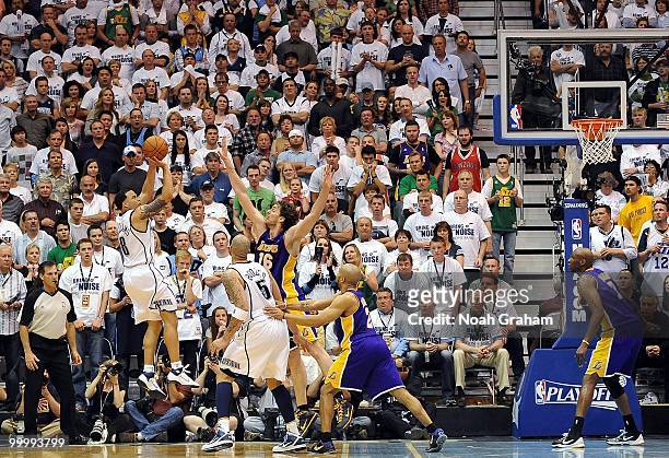 Deron Williams of the Utah Jazz shoots a jump shot against Pau Gasol and Derek Fisher of the Los Angeles Lakers in Game Three of the Western...
