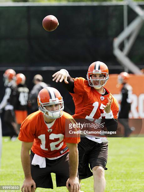 Quarterback Jake Delhomme of the Cleveland Browns throws a pass as Colt McCoy looks on during the team's organized team activity on May 19, 2010 at...