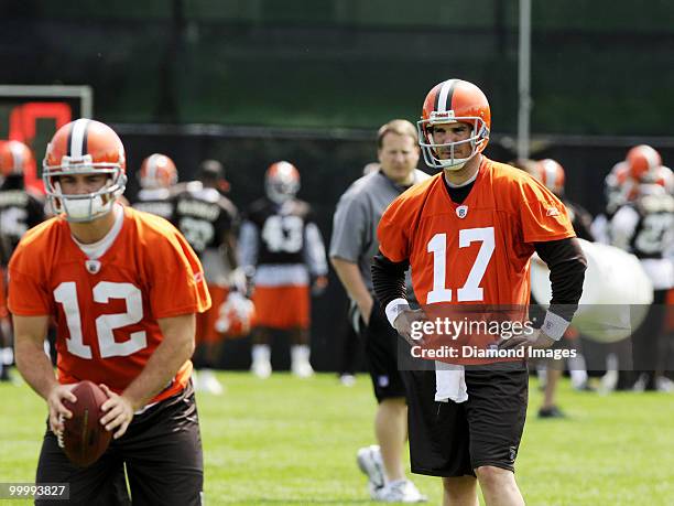 Quarterback Jake Delhomme of the Cleveland Browns watches Colt McCoy as Head Coach Eric Mangini looks on during the team's organized team activity on...