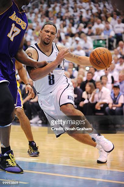 Deron Williams of the Utah Jazz drives to the basket against Andrew Bynum of the Los Angeles Lakers in Game Three of the Western Conference...