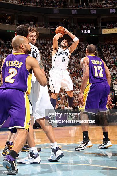 Carlos Boozer of the Utah Jazz shoots a jump shot over Derek Fisher and Shannon Brown of the Los Angeles Lakers in Game Three of the Western...