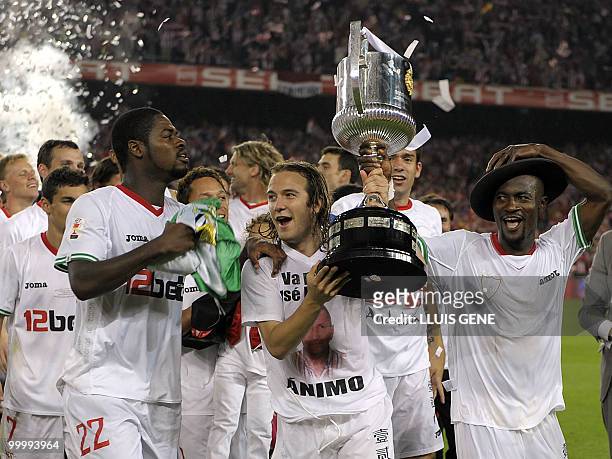 Sevilla's players celebrate after winning the King�s Cup final match against Atletico Madrid at the Camp Nou stadium in Barcelona on May 19, 2010....