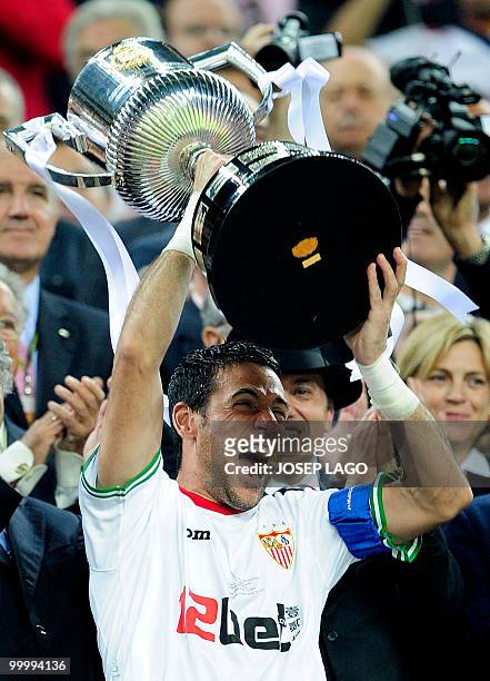 Sevilla's captain goalkeeper Andres Palop celebrates with the trophy after winning the King's Cup final match against Atletico Madrid at the Camp Nou...