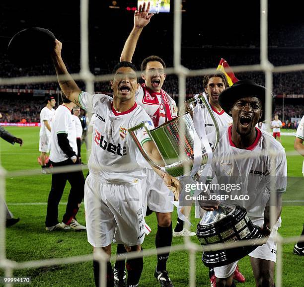 Sevilla's players celebrate with the trophy after winning the King's Cup final match against Atletico Madrid at the Camp Nou stadium in Barcelona on...