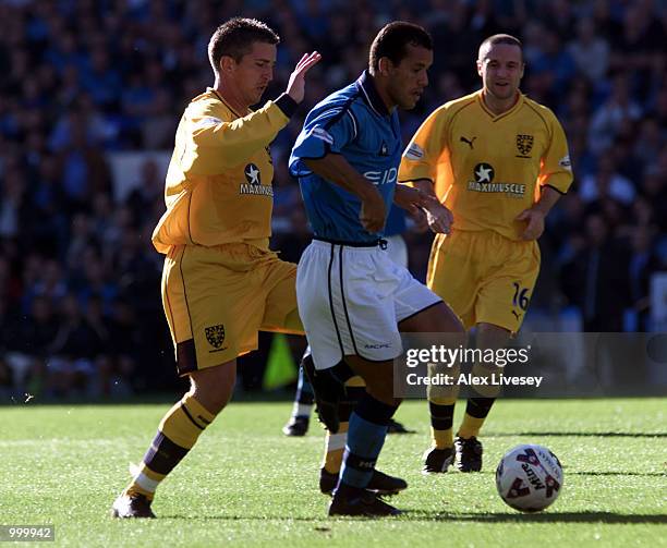 Ali Benarbia of Man City holds off a challenge from Andy Roberts of Wimbledon during the Nationwide Division One game between Manchester City and...