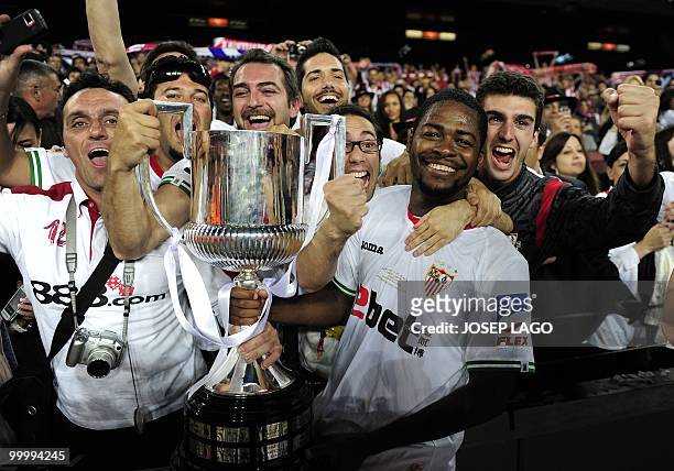 Sevilla's players celebrate with the trophy after winning the King's Cup final match against Atletico Madrid at the Camp Nou stadium in Barcelona on...