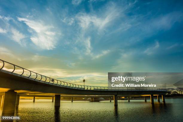 atardecer en el puenta laguna garzon - atardecer playa stock pictures, royalty-free photos & images