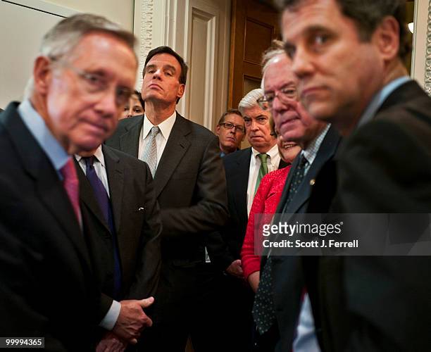 May 19: At left, Senate Majority Leader Harry Reid, D-Nev., huddles with angry and frustrated fellow Democrats before a news conference after their...
