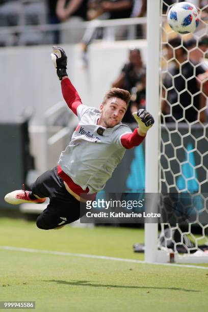 Tyler Miller of the Los Angeles Football Club dives to block a shot on goal during a warmup exercise at Banc of California Stadium on July 15, 2018...