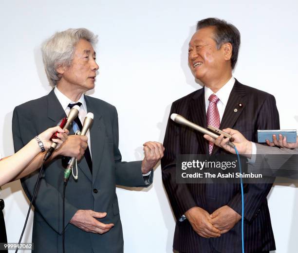 Former Prime Minister Junichiro Koizumi and Liberal Party leader Ichiro Ozawa talk to media reporters after addressing at a political school hosted...