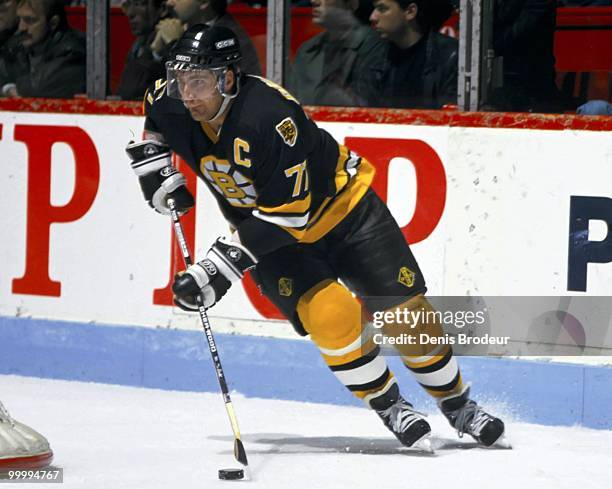 Raymond Bourque of the Boston Bruins skates with the puck against the Montreal Canadiens in the 1980's at the Montreal Forum in Montreal, Quebec,...