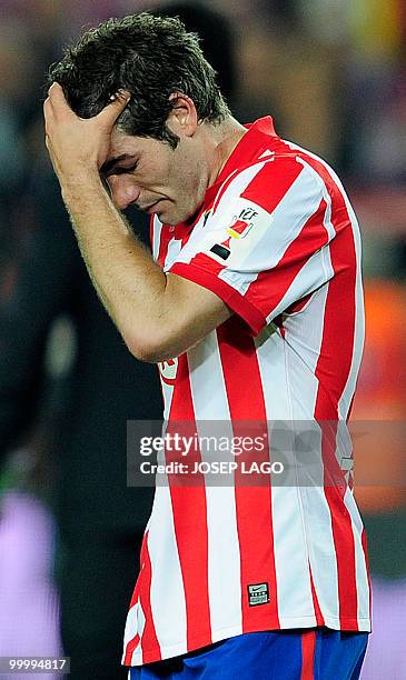 Atletico Madrid's captain Antonio Lopez reats after Sevilla won the King's Cup final match against Atletico Madrid at the Camp Nou stadium in...