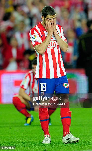 Atletico Madrid's defender Alvaro Dominguez Soto reacts after Sevilla won the King's Cup final match against Atletico Madrid at the Camp Nou stadium...