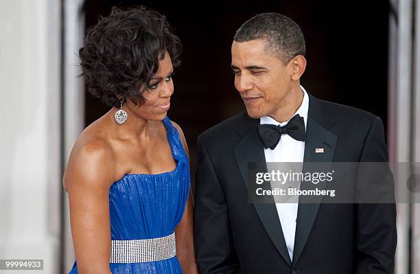 President Barack Obama and First Lady Michelle Obama wait to greet Mexican President Felipe Calderon and his wife on the North Portico of the White...