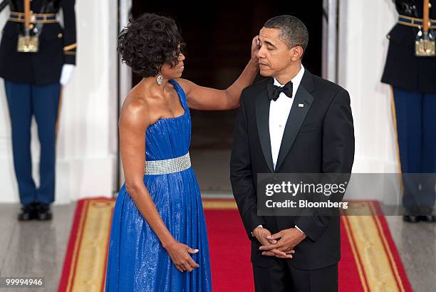 President Barack Obama and First Lady Michelle Obama wait to greet Mexican President Felipe Calderon and his wife on the North Portico of the White...