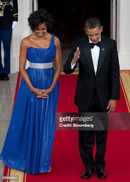 President Barack Obama and First Lady Michelle Obama wait to greet Mexican President Felipe Calderon and his wife on the North Portico of the White...