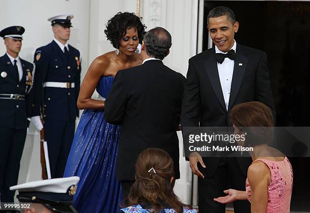 President Barack Obama , and his wife first lady Michelle Obama greet Mexican President Felipe Calderon after his arrival for the State Dinner at the...