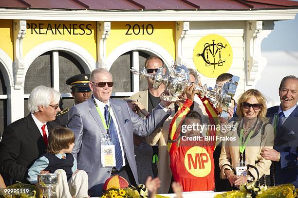 Preakness Stakes: Lookin at Lucky jockey Martin Garcia victorious with Woodlawn Vase trophy during celebration after winning 135th Running at Pimlico...