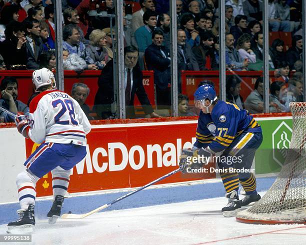 Pierre Turgeon of the Buffalo Sabres skates against Larry Trader of the Montreal Canadiens in the late 1980's at the Montreal Forum in Montreal,...