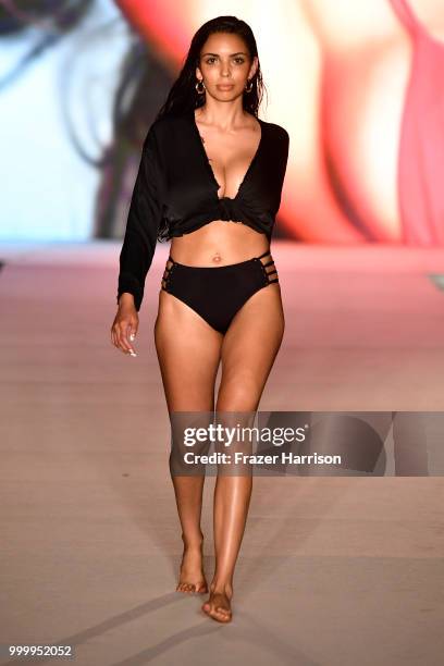 Model walks the runway for the 2018 Sports Illustrated Swimsuit show at PARAISO during Miami Swim Week at The W Hotel South Beach on July 15, 2018 in...