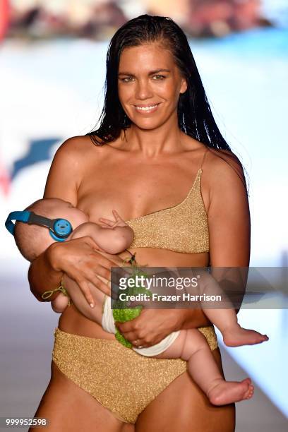 Model breastfeeds while walking the runway for the 2018 Sports Illustrated Swimsuit show at PARAISO during Miami Swim Week at The W Hotel South Beach...