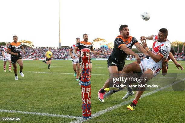 Nene Macdonald of the Dragons is tackled into touch during the round 18 NRL match between the St George Illawarra Dragons and the Wests Tigers at UOW...