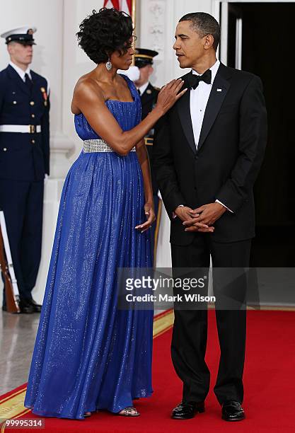 First lady Michelle Obama stands with her husband U.S President Barack Obama as they wait for Mexican President Felipe Calderon and his wife...
