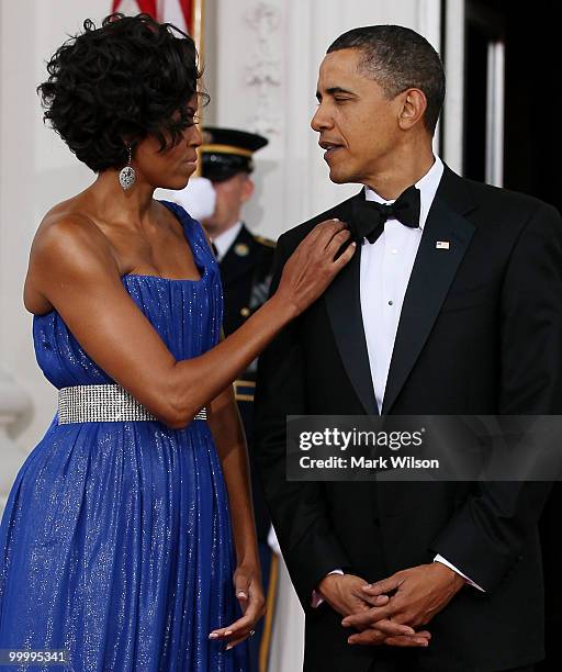 First lady Michelle Obama stands with her husband U.S President Barack Obama, as they wait for Mexican President Felipe Calderon and his wife...