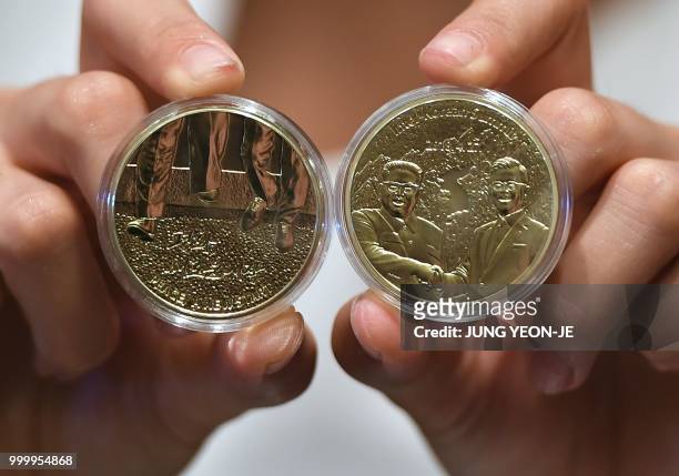 South Korean model shows medallions commemorating the historic inter-Korean summit between Moon Jae-in and Kim Jong Un during an unveiling ceremony...